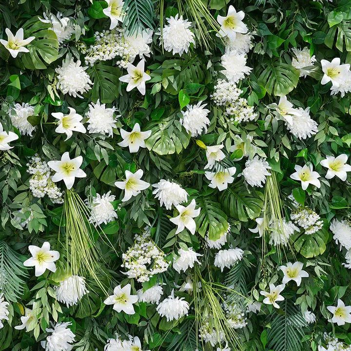 Close-up of decorative flower wall with lush greenery and white florals.