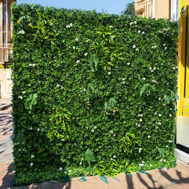 Close-up view of a vibrant green flower wall with foliage for parties and events.