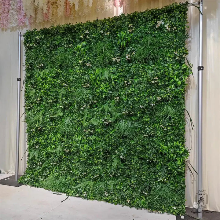 Decorative flower wall featuring lush green plants for a natural event backdrop.