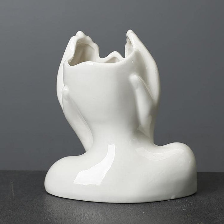 Minimalist decorative face vase with hands framing the face