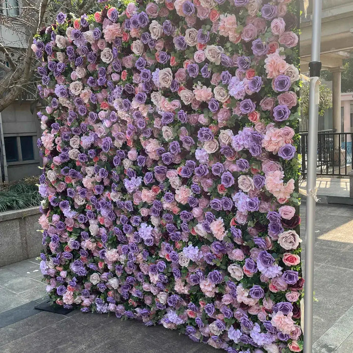 Floral wall backdrop featuring beautiful purple and pink roses for event decorations.