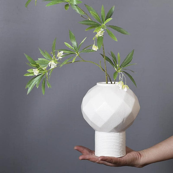 White polyhedron ceramic vase on display