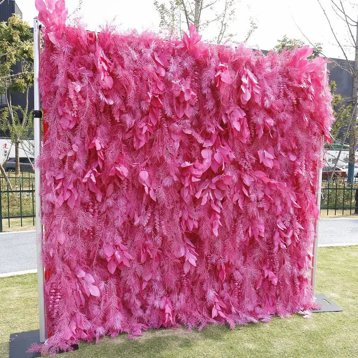 Bold pink flower wall backdrop with cascading fern textures for weddings and events