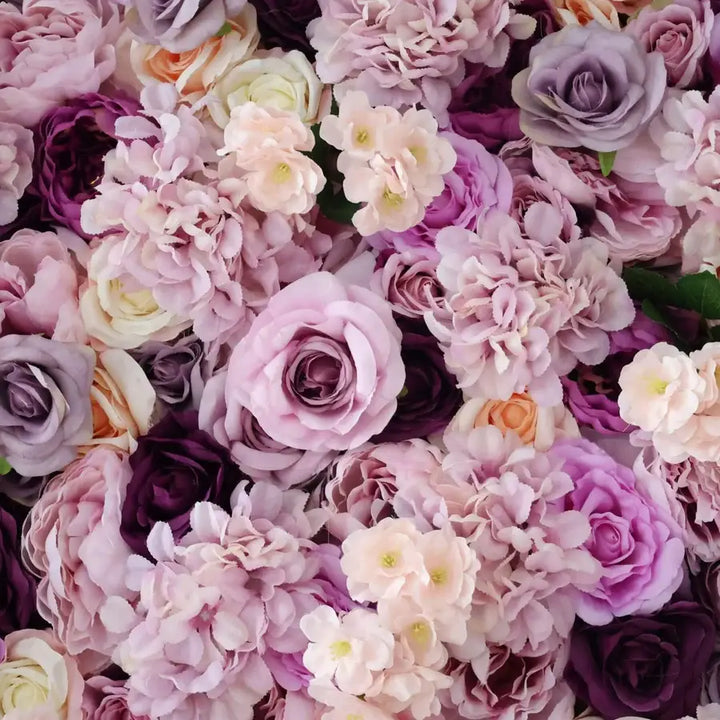 Close-up of lavender and pink roses in a floral wall backdrop for events.