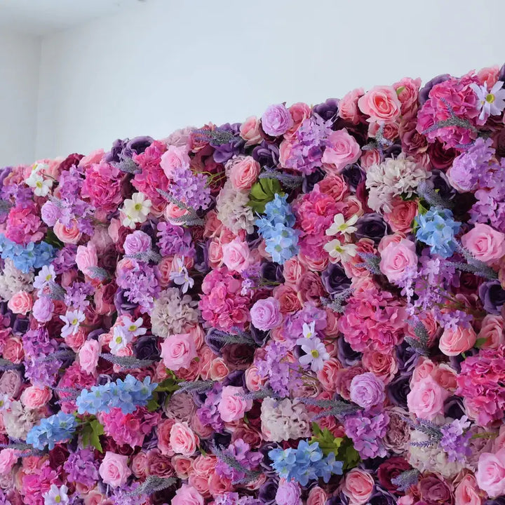 Decorative flower wall featuring pink and purple roses for party decorations.