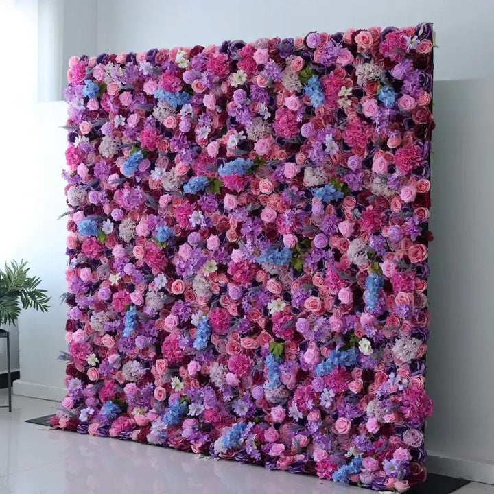 Decorative flower wall featuring pink and purple roses for party decorations.