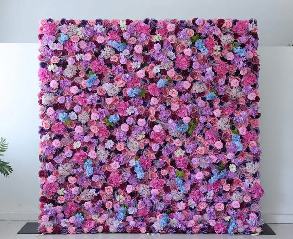 Vibrant pink and purple flower wall backdrop for weddings and events.