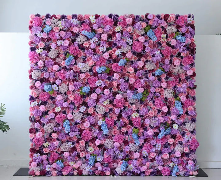 Vibrant pink and purple flower wall backdrop for weddings and events.