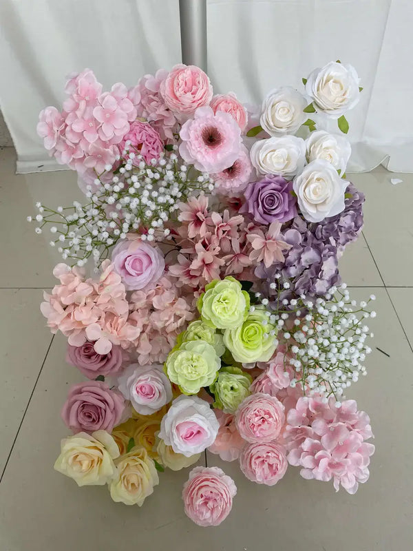 Soft pink and lavender flower wall backdrop with roses, hydrangeas, and baby’s breath, perfect for weddings.
