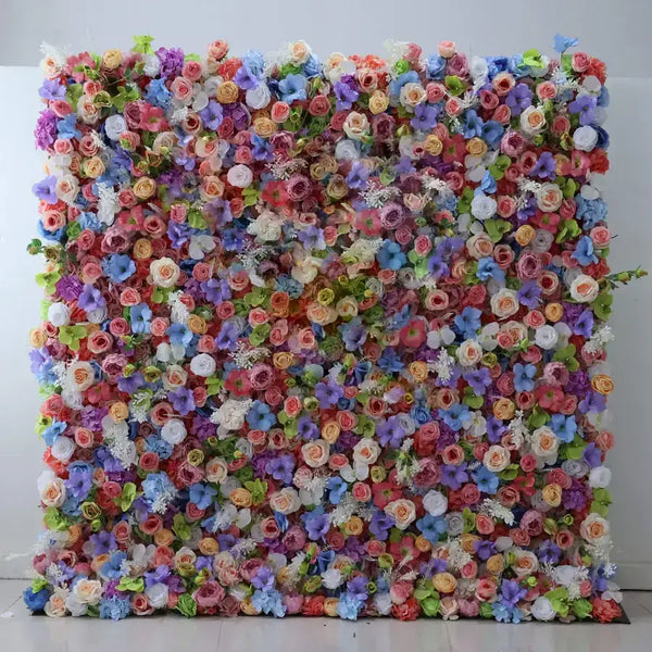 Colorful floral wall backdrop featuring a mix of roses, violets, and daisies, perfect for weddings and parties.