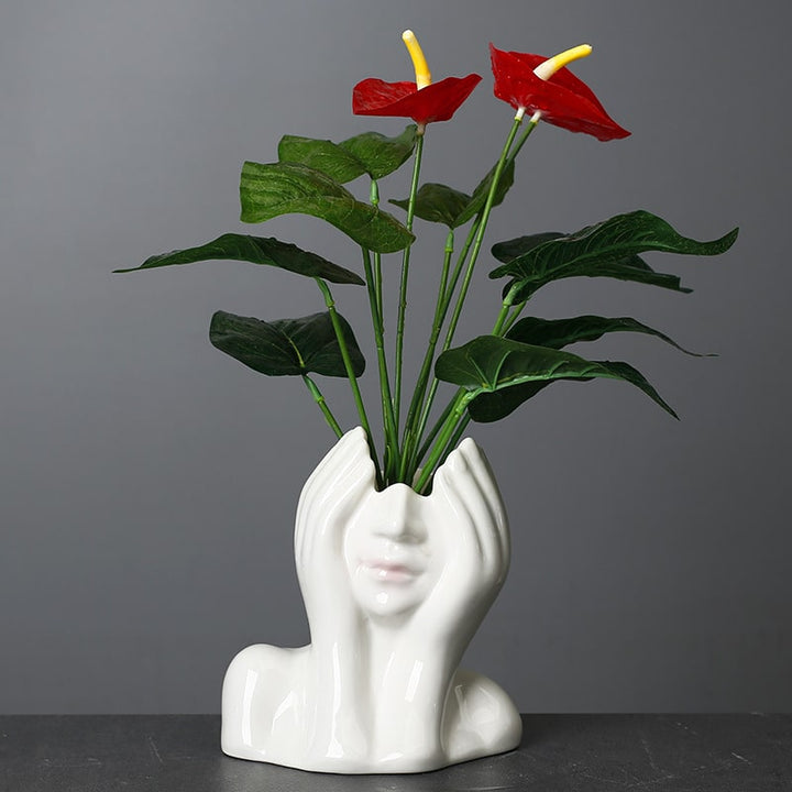 Minimalist decorative face vase with hands framing the face