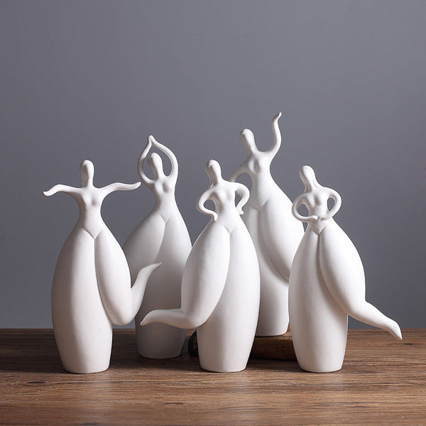 Modern Nordic ceramic dancer figurines on wooden table