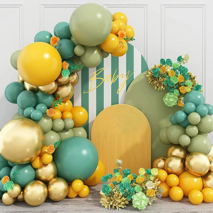 Vibrant yellow and green balloon arch with floral accents for baby shower
