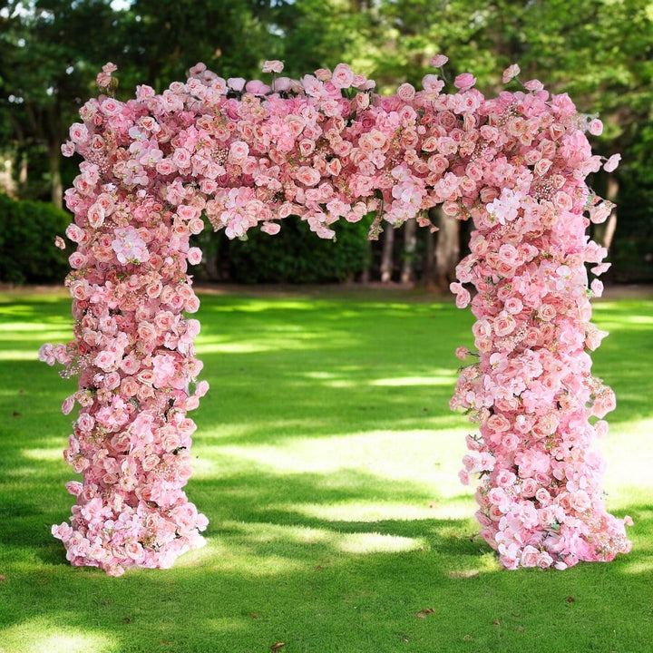 Romantic flower arch wedding decor with lush pink blooms.
