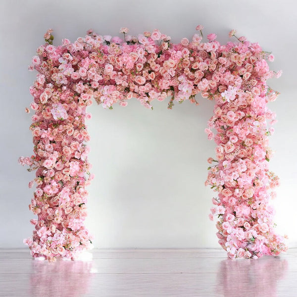 Elegant pink rose wedding arch for ceremony backdrop.
