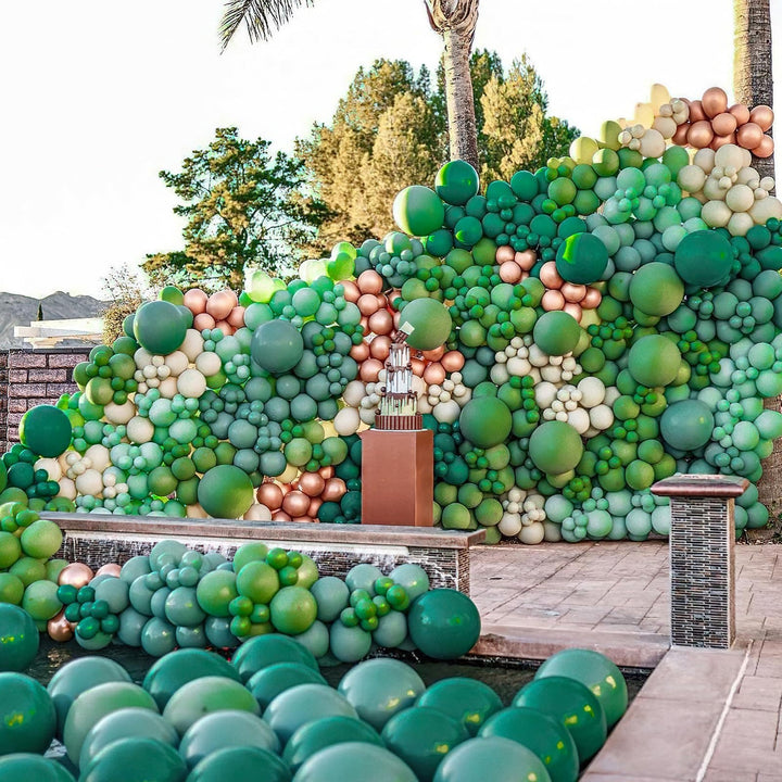 Sophisticated balloon garland in green, cream, and metallic for upscale celebrations
