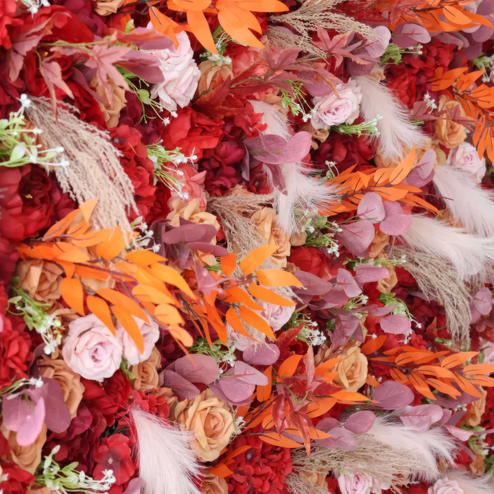 Decorative flower wall with dried foliage and feathers, perfect for fall weddings and parties.