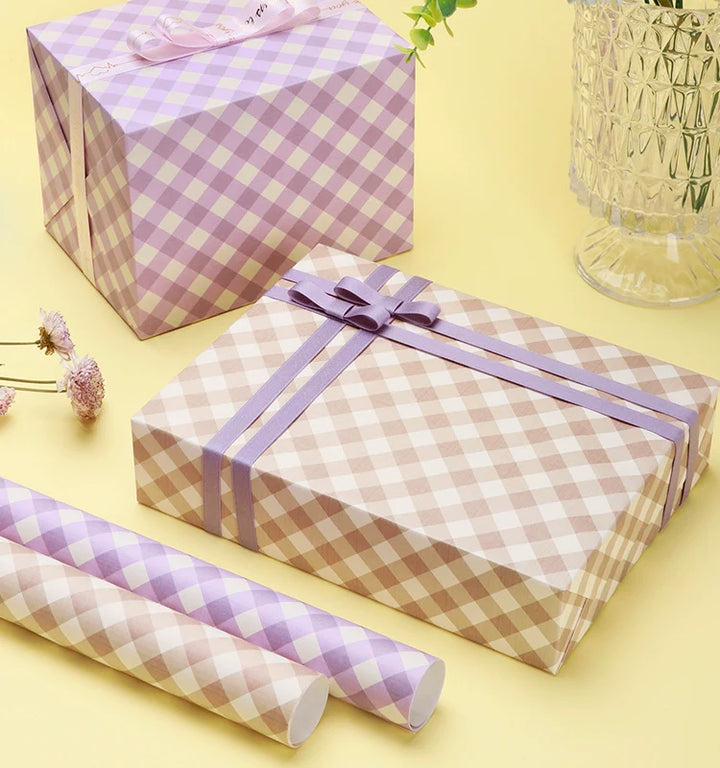 Elegant pink wrapping paper with a gingham design for gifts.