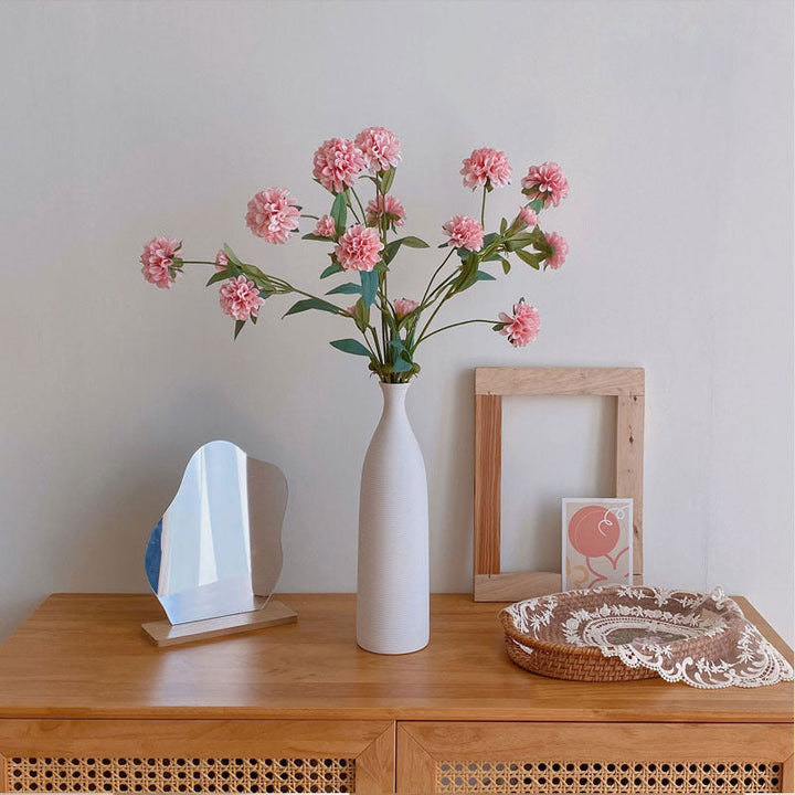 Set of elegant white ceramic vases in living room