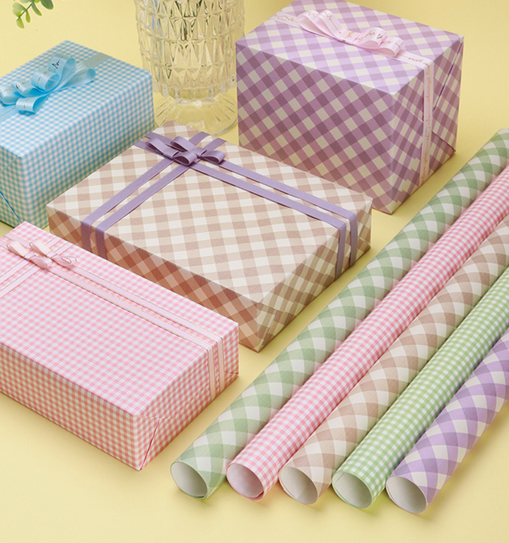 Flower bouquet wrapped in soft pink gingham paper.