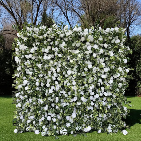 Full frontal view of a white rose and greenery flower wall backdrop
