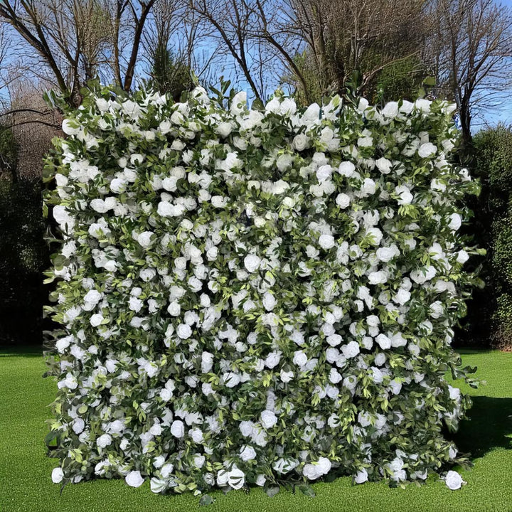 Full frontal view of a white rose and greenery flower wall backdrop