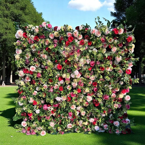 Lush flower wall backdrop with red, pink, and ivory roses and greenery