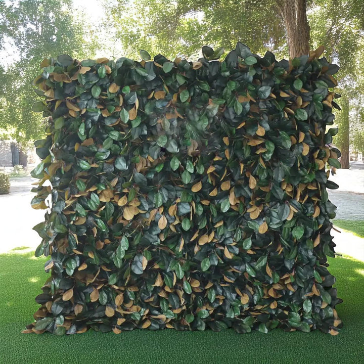 Dense artificial foliage flower wall backdrop with green and brown leaves