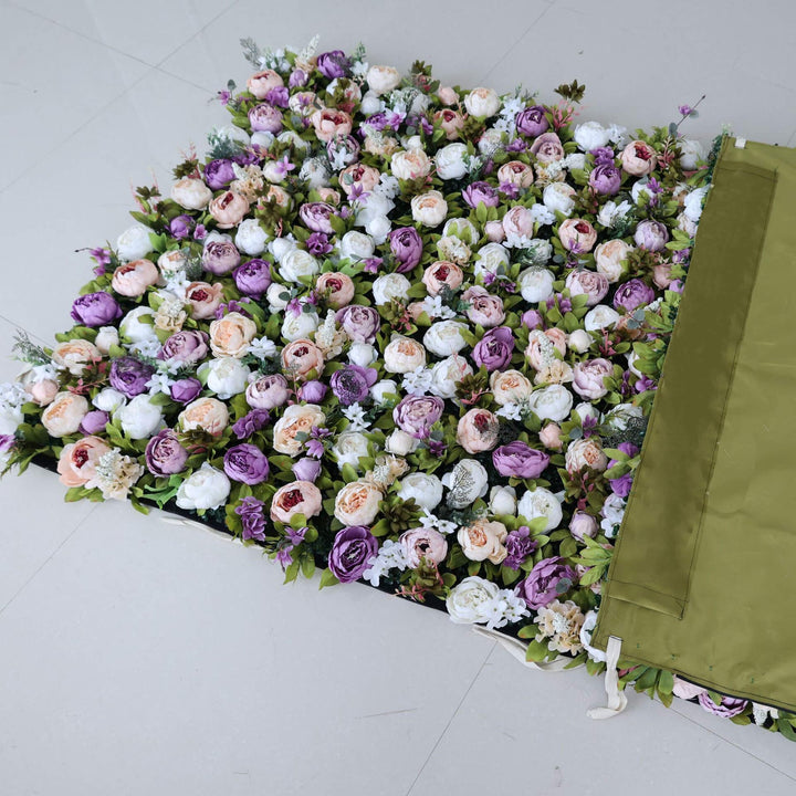 Elegant mix of lavender and cream roses on a decorative flower wall backdrop.
