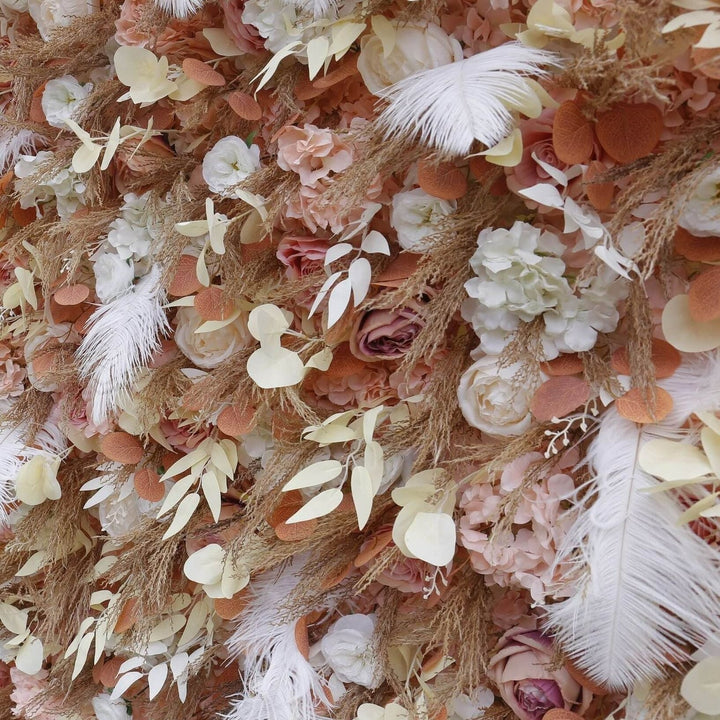 Luxurious floral wall backdrop featuring soft blush roses, dried foliage, and white feathers.

