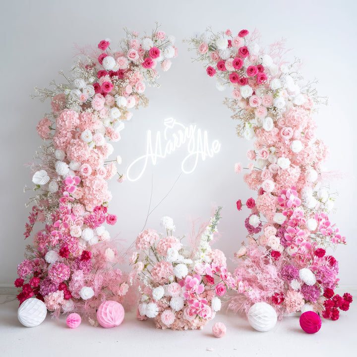 Delicate pink and white floral arch with a soft blend of roses and hydrangeas, perfect for adding a romantic touch to weddings and elegant events.