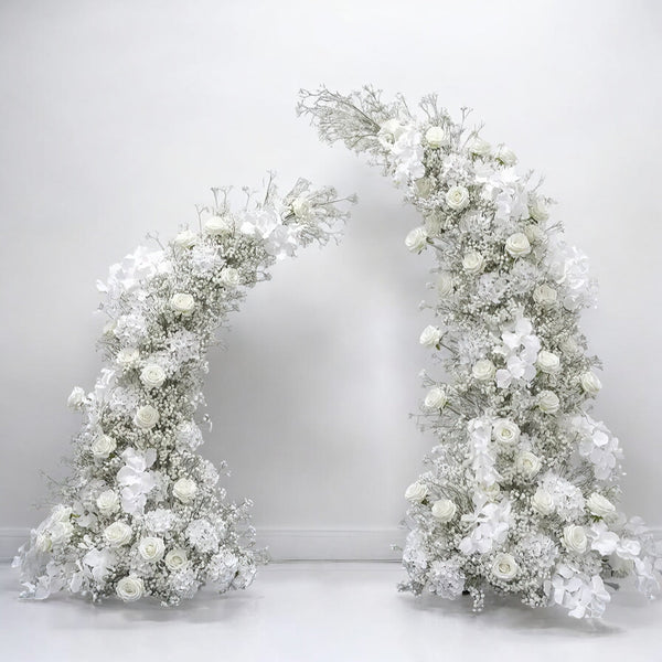 Elegant white floral wedding arch with roses and delicate baby's breath, perfect for creating a timeless and classic backdrop for weddings and sophisticated events.