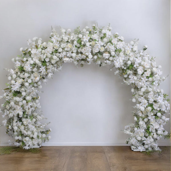 Graceful white floral arch adorned with lush blooms and greenery, offering a romantic and classic look for wedding ceremonies and elegant occasions.