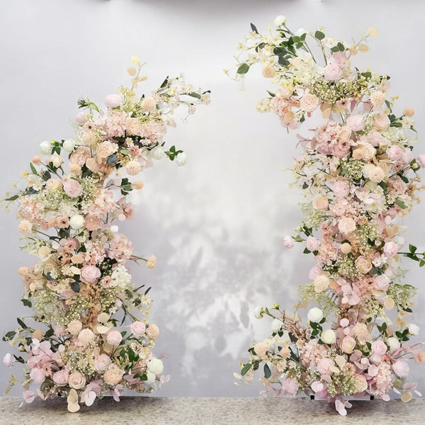 Elegant floral arch arrangement with soft pink and cream flowers, perfect for creating a romantic atmosphere at weddings and special events.