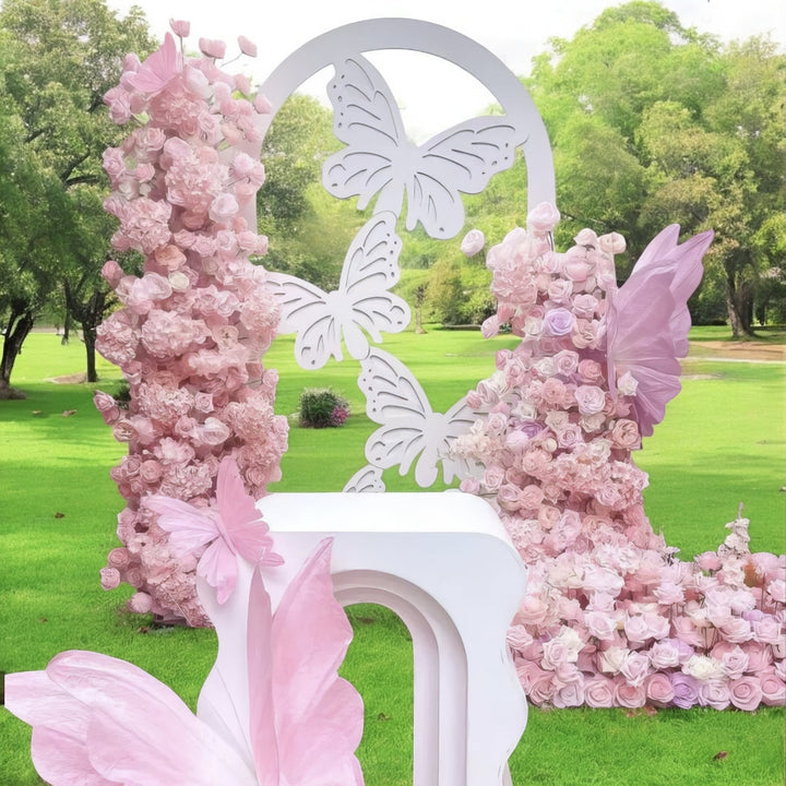 Enchanting butterfly-themed floral display with blush pink roses, perfect for whimsical outdoor weddings and fairytale-inspired events.