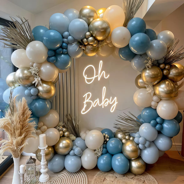 Blue and gold balloon arch with elegant decor for baby shower
