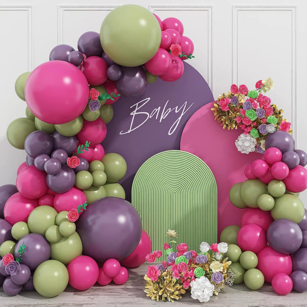 Bold pink and purple balloon arch with green accents for baby shower
