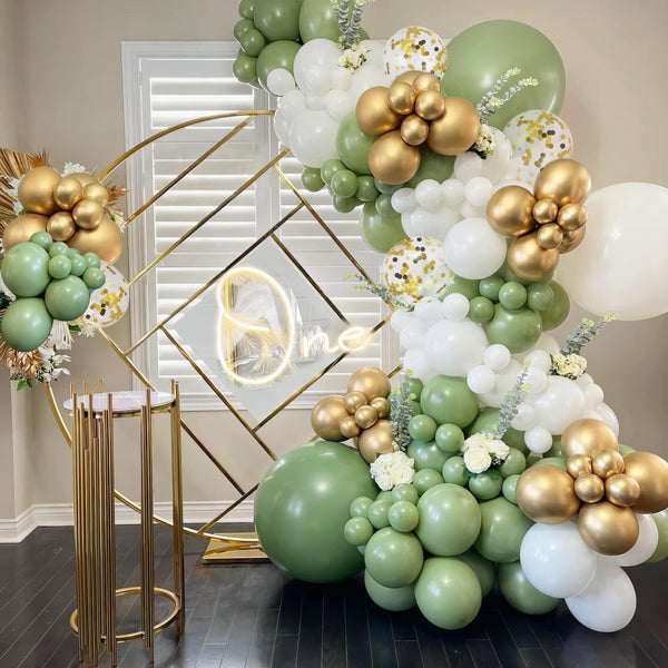 Balloon garland in green, gold, and white with confetti balloons for "Wild One" celebration
