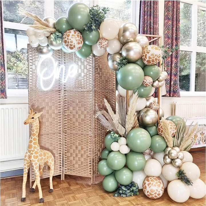 Safari-themed balloon arch with giraffe print accents for first birthday
