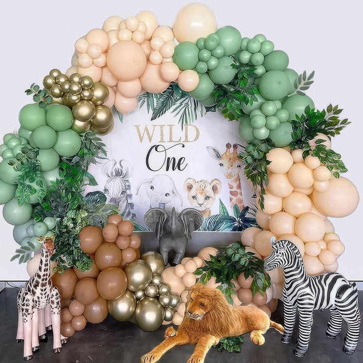 Wild One birthday party balloon garland with jungle animal decorations
