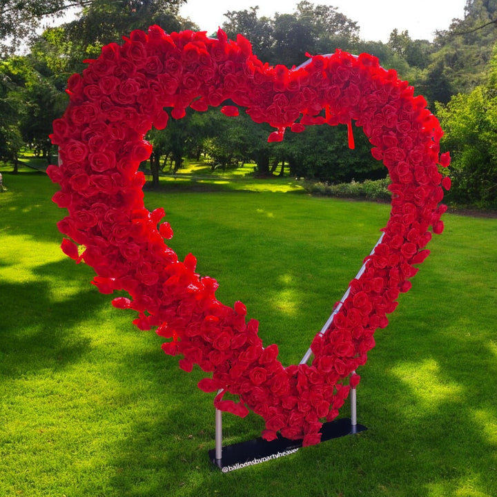 Heart-shaped red rose floral backdrop, perfect for romantic outdoor events and weddings, adding a bold and dramatic touch to any celebration.