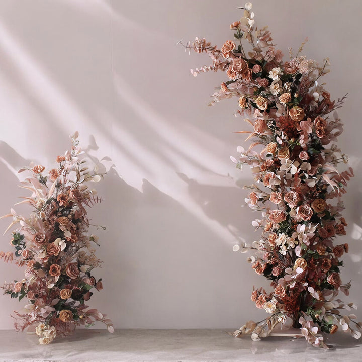 Chic floral display with muted blush, rose gold, and soft pink tones, creating a modern and elegant backdrop for indoor weddings and sophisticated events.