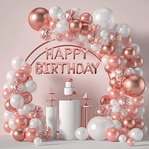 Rose gold and white balloon arch with "Happy Birthday" lettering
