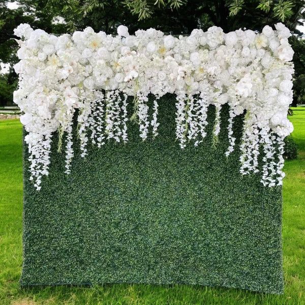 White floral cascading backdrop with greenery base
