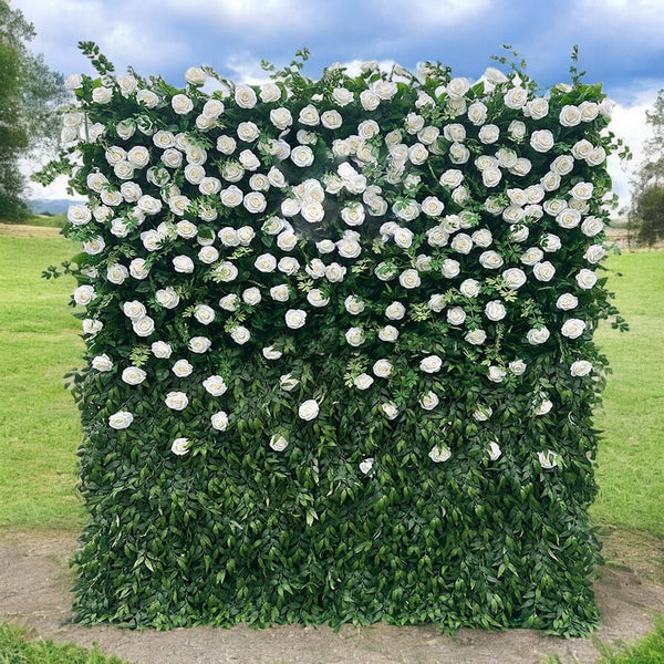Lush green and white floral wall backdrop for events.
